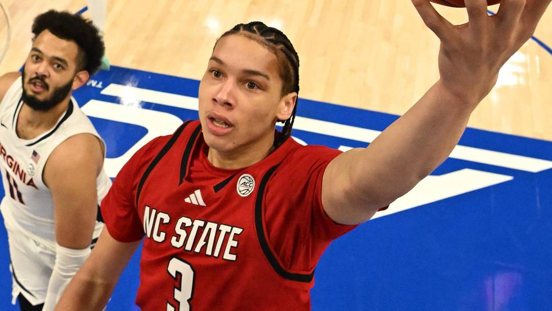 Mar 12, 2026; Charlotte, NC, USA; NC State Wolfpack guard Matt Able (3) scores as Virginia Cavaliers forward Devin Tillis (11) defends in the first half at Spectrum Center. Mandatory Credit: Bob Donnan-Imagn Images