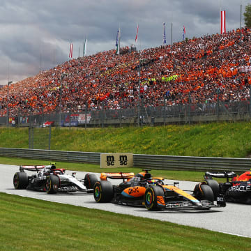 Sergio Perez of Mexico driving the (11) Oracle Red Bull Racing RB19 leads Oscar Piastri of Australia driving the (81) McLaren MCL60 Mercedes and Yuki Tsunoda of Japan driving the (22) Scuderia AlphaTauri AT04 on track during the F1 Grand Prix of Austria at Red Bull Ring on July 02, 2023 in Spielberg, Austria.