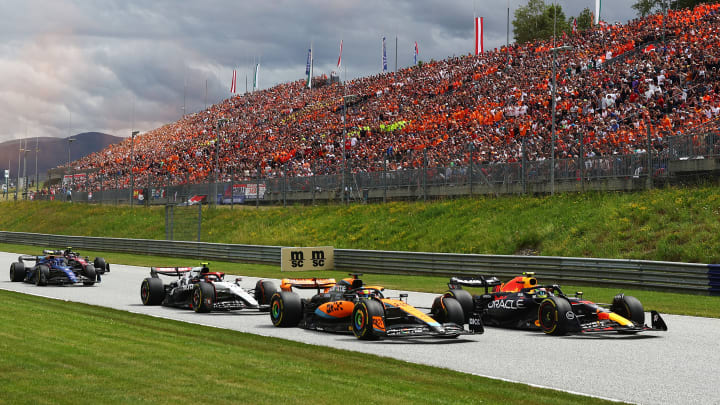 Sergio Perez of Mexico driving the (11) Oracle Red Bull Racing RB19 leads Oscar Piastri of Australia driving the (81) McLaren MCL60 Mercedes and Yuki Tsunoda of Japan driving the (22) Scuderia AlphaTauri AT04 on track during the F1 Grand Prix of Austria at Red Bull Ring on July 02, 2023 in Spielberg, Austria.