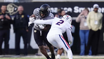 Nov 1, 2025; Boulder, Colorado, USA; Arizona Wildcats defensive back Treydan Stukes (2) tackles Colorado Buffaloes running back Micah Welch (29) at Folsom Field. Mandatory Credit: Ron Chenoy-Imagn Images