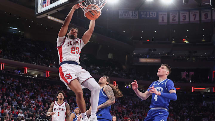 Feb 9, 2026; New York, New York, USA;  St. John's basketball forward Bryce Hopkins (23) dunks past Xavier Musketeers forward Filip Borovicanin (4) in the second half at Madison Square Garden
