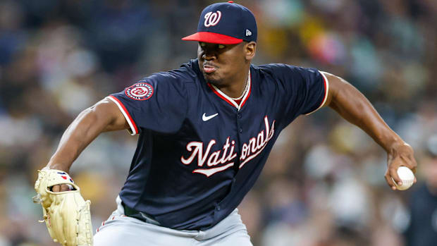 Washington Nationals relief pitcher Jose A. Ferrer throws while wearing a blue jersey with Nationals in script across front