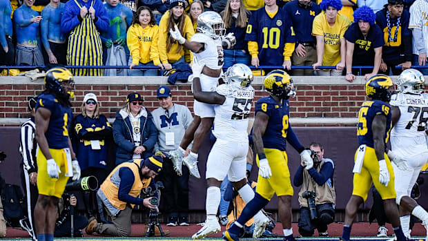 Oregon running back Noah Whittington (6) is lifted by offensive lineman Marcus Harper II (55) to celebrate a touchdown agains