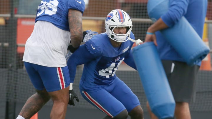 Bills edge Von Miller cuts around Austin Johnson as he rushes the quarterback during individual line drills.