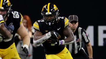 Dec 2, 2023; Indianapolis, IN, USA; Iowa Hawkeyes running back Kaleb Johnson (2) runs during the first half of the Big Ten Championship game against the Michigan Wolverines at Lucas Oil Stadium. Mandatory Credit: Trevor Ruszkowski-Imagn Images