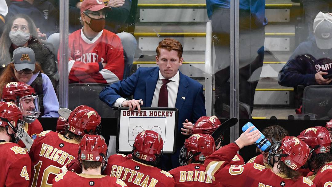 Apr 9, 2022; Boston, MA, USA; Denver Pioneers head coach David Carle talks with his team during a timeout during the third period of the 2022 Frozen Four college ice hockey national championship game against the Minnesota State Mavericks at TD Garden. Mandatory Credit: Brian Fluharty-Imagn Images