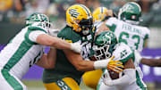 Jun 11, 2023; Edmonton, Alberta, CAN; Saskatchewan Roughriders running back Frankie Hickson (20) is tackled by Edmonton Elks defensive lineman J-Min Pelley (96) during the second half at Commonwealth Stadium. Mandatory Credit: Perry Nelson-Imagn Images