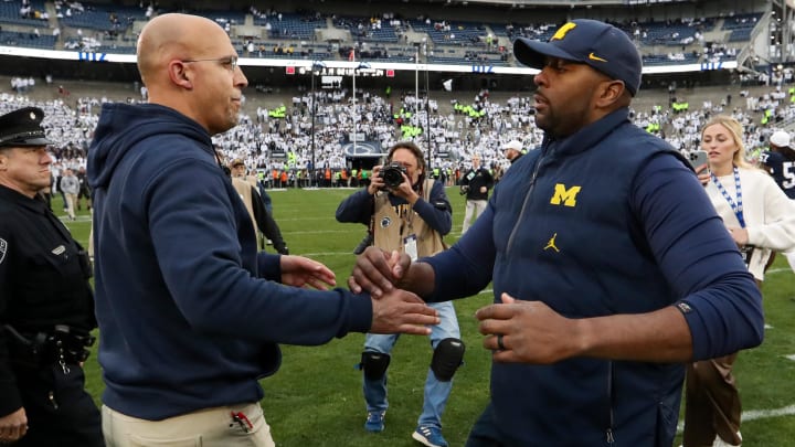 Nov 11, 2023; University Park, Pennsylvania, USA; Penn State Nittany Lions head coach James Franklin (left) shakes hands with Michigan Wolverines offensive line coach Sherrone Moore (right) following a game at Beaver Stadium. Michigan won 24-15. Mandatory Credit: Matthew O'Haren-USA TODAY Sports