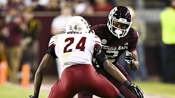 Nov 16, 2024; College Station, Texas, USA; Texas A&M Aggies wide receiver Terry Bussey (2) runs the ball as New Mexico State Aggies cornerback Dakerric Hobbs (24) defends during the first half at Kyle Field. Mandatory Credit: Maria Lysaker-Imagn Images 