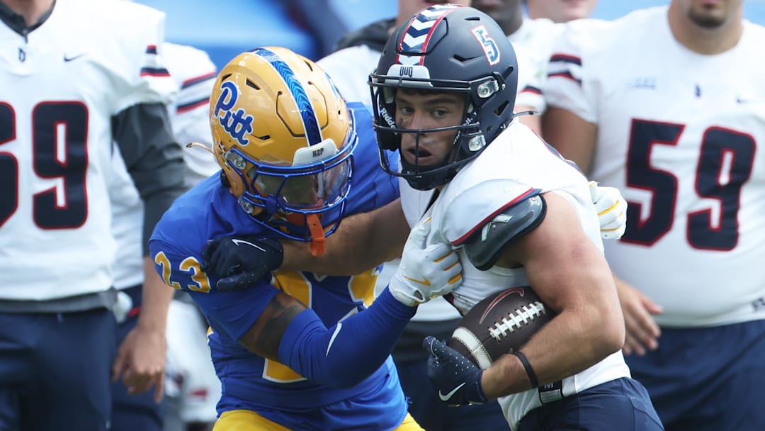 Aug 30, 2025; Pittsburgh, Pennsylvania, USA; Duquesne Dukes wide receiver Joey Isabella (5) runs after a catch against Pittsburgh Panthers defensive back Davion Pritchard (23) during the third quarter at Acrisure Stadium. Mandatory Credit: Charles LeClaire-Imagn Images