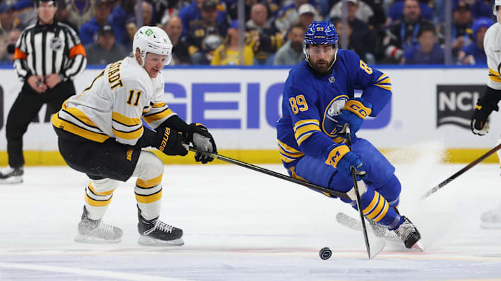 Apr 21, 2026; Buffalo, New York, USA; Buffalo Sabres right wing Alex Tuch (89) looks to control the puck as Boston Bruins center Casey Mittelstadt (11) defends during the first period in game two of the first round of the 2026 Stanley Cup Playoffs at KeyBank Center. Mandatory Credit: Timothy T. Ludwig-Imagn Images
