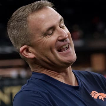 Aug 23, 2025; New Orleans, Louisiana, USA; Denver Broncos special teams coordinator/assistant head coach Darren Rizzi greets New Orleans Saints owner Gayle Benson on the sideline at Caesars Superdome. 
