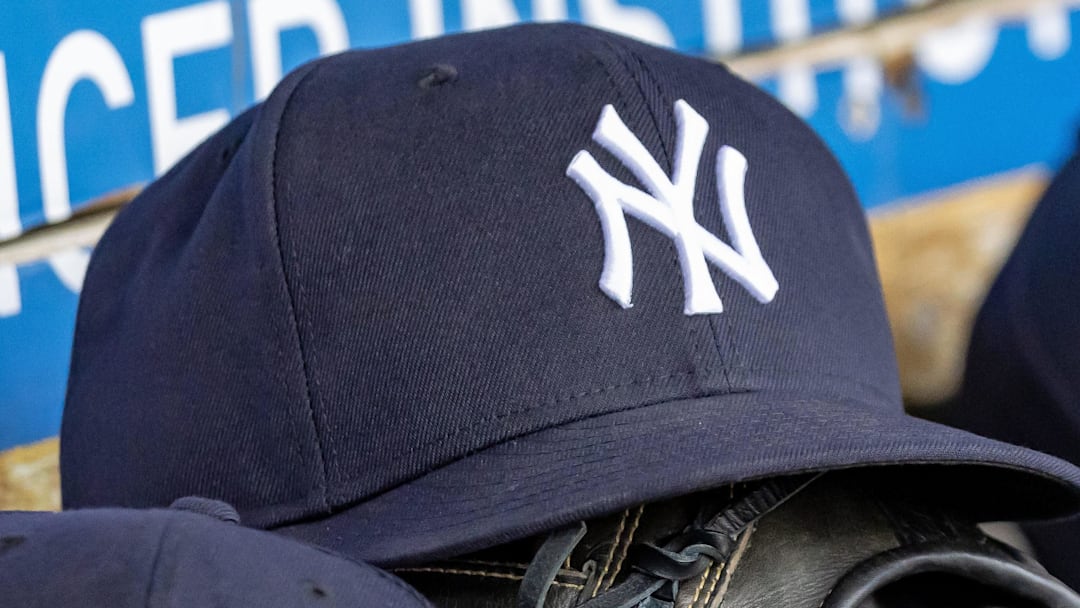 Apr 7, 2025; Detroit, Michigan, USA; New York Yankees baseball hats and gloves in the dugout out in the eighth inning against the Detroit Tigers at Comerica Park. 