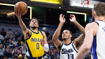 Mar 31, 2025; Indianapolis, Indiana, USA; Indiana Pacers guard Tyrese Haliburton (0) shoots the ball while Sacramento Kings forward Keegan Murray (13)  defends in the first half at Gainbridge Fieldhouse. Mandatory Credit: Trevor Ruszkowski-Imagn Images