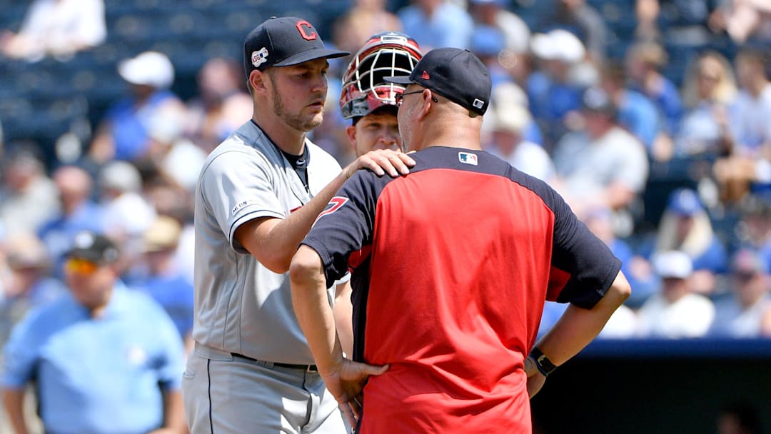 Jul 28, 2019; Kansas City, MO, USA; Cleveland Indians manager Terry Francona (77) talks with starting pitcher Trevor Bauer (47) at the mound in the fifth inning against the Kansas City Royals at Kauffman Stadium. Mandatory Credit: Denny Medley-Imagn Images