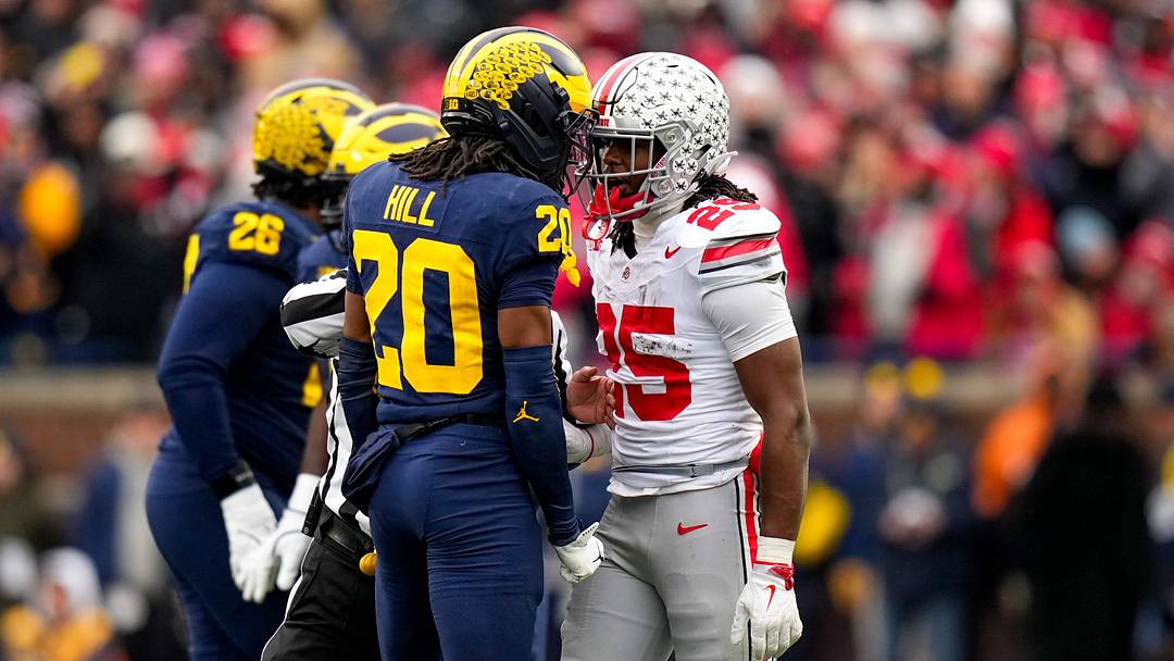 Michigan Wolverines defensive back Jyaire Hill (20) and Ohio State Buckeyes running back Bo Jackson (25) exchange words in the first half of the NCAA football game at Michigan Stadium on Saturday, Nov. 29, 2025 in Ann Arbor, Michigan.