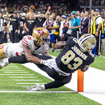 Sep 14, 2025; New Orleans, Louisiana, USA;  New Orleans Saints tight end Juwan Johnson (83) catches a touchdown against San Francisco 49ers safety Marques Sigle (36) during the first half at Caesars Superdome. Mandatory Credit: Stephen Lew-Imagn Images