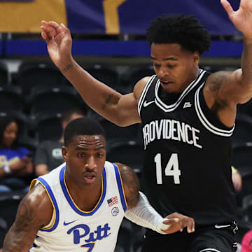 Oct 19, 2025; Pittsburgh, PA, USA;  Pittsburgh Panthers guard Damarco Minor (7) brings the ball up court against  Providence Friars guard Corey Floyd Jr. (14) during the first half at the Petersen Events Center. Mandatory Credit: Charles LeClaire-Imagn Images