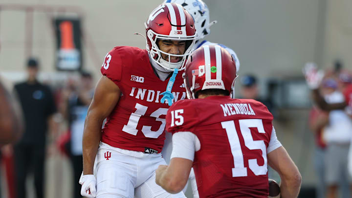 Indiana wide receiver Elijah Sarratt (13) and quarterback Fernando Mendoza (15) are favored against Illinois. 