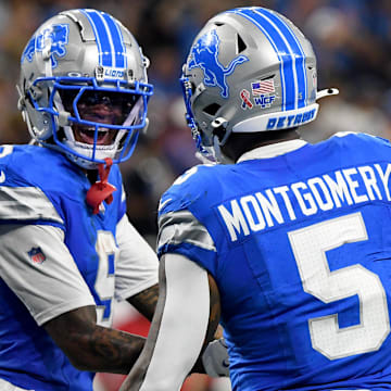 Detroit Lions running back David Montgomery (5) celebrates with Detroit Lions wide receiver Jameson Williams (9)