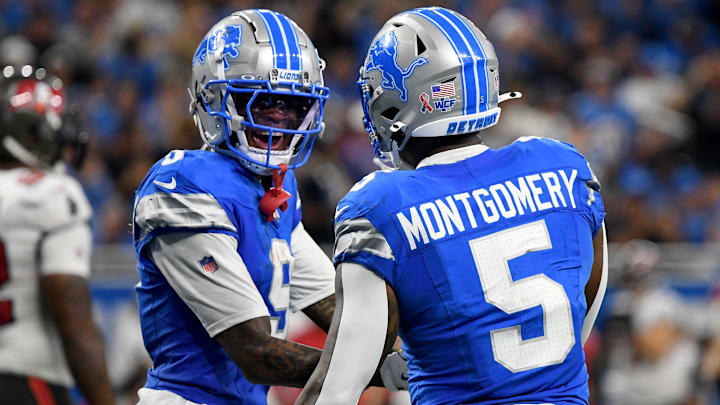 Detroit Lions running back David Montgomery (5) celebrates with Detroit Lions wide receiver Jameson Williams (9)