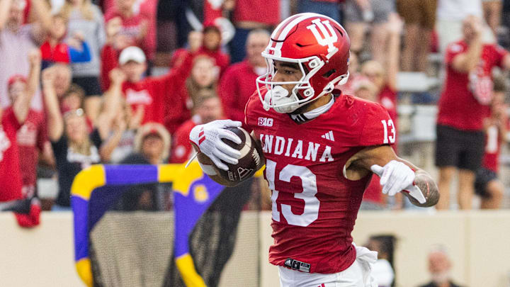 Sep 6, 2024; Bloomington, Indiana, USA; Indiana Hoosiers wide receiver Elijah Sarratt (13) runs the ball for a touchdown in the first quarter against the Western Illinois Leathernecks at Memorial Stadium. Mandatory Credit: Trevor Ruszkowski-Imagn Images