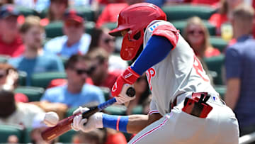 Apr 13, 2025; St. Louis, Missouri, USA; Philadelphia Phillies outfielder Johan Rojas (23) bunts in the second inning against the St. Louis Cardinals at Busch Stadium. 