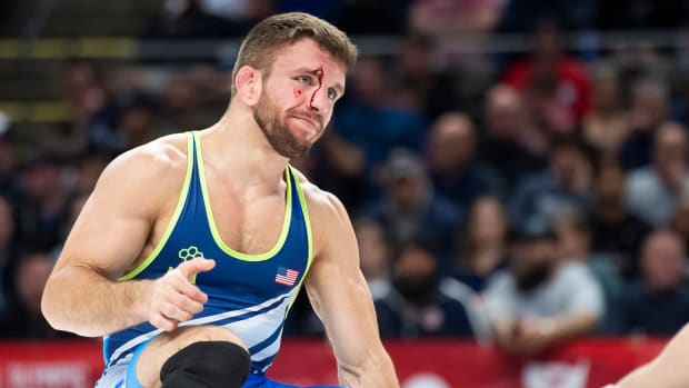 Wrestler Zain Retherford pauses during a match as blood runs down his face at the U..S. Olympic Wrestling Trials.