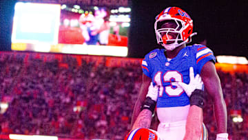 Florida Gators offensive lineman Austin Barber (58) hoists Florida Gators running back Jadan Baugh (13) into the air after his touchdown during the first half at Ben Hill Griffin Stadium in Gainesville, FL on Saturday, October 19, 2024 against the Kentucky Wildcats. [Doug Engle/Gainesville Sun]