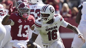Oct 12, 2024; Tuscaloosa, Alabama, USA;  South Carolina Gamecocks quarterback LaNorris Sellers (16) peels away from pressure by Alabama Crimson Tide defensive back Malachi Moore (13) at Bryant-Denny Stadium. Alabama defeated South Carolina 27-25. Mandatory Credit: Gary Cosby Jr.-Imagn Images
