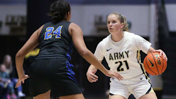 Army's Reese Ericson looks for an open teammate as Emmanuel College's Kiera Eubanks covers her during Monday's game on November 7, 2022.