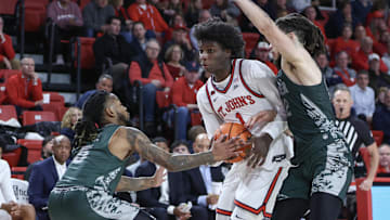 Nov 13, 2024; Queens, New York, USA;  St. John's basketball guard Kadary Richmond (1) looks to drive past Wagner Seahawks guards Zae Blake (5) and Zaire Williams (12) in the second half at Carnesecca Arena.