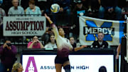 Assumption’s Taylor McKenzie gets a shot over the net against Mercy in the third set in the first round of the KHSAA Girls State Volleyball Tournament. Monday on November 3, 2025