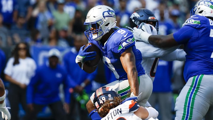 Sep 8, 2024; Seattle, Washington, USA; Seattle Seahawks running back Kenneth Walker III (9) breaks a tackle attempt by Denver Broncos linebacker Alex Singleton (49) to rush for a touchdown during the third quarter at Lumen Field. Mandatory Credit: Joe Nicholson-Imagn Images