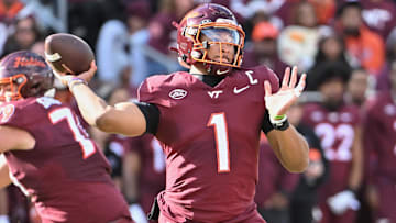 Nov 1, 2025; Blacksburg, Virginia, USA;  Virginia Tech Hokies quarterback Kyron Drones (1) throws a pass against the Louisville Cardinals at Lane Stadium. Mandatory Credit: Brian Bishop-Imagn Images