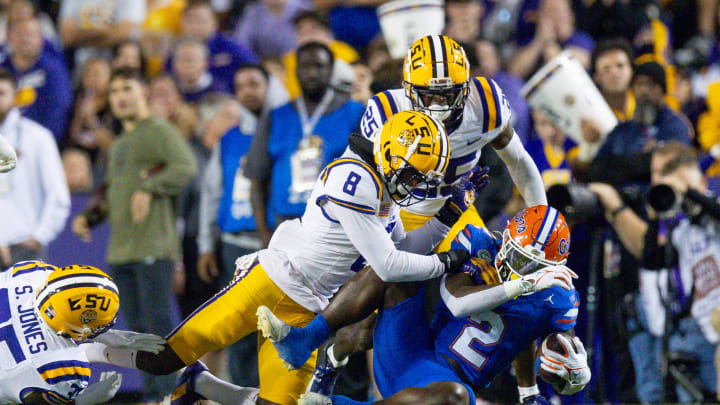 Nov 11, 2023; Baton Rouge, Louisiana, USA;  LSU Tigers safety Major Burns (8) tackles Florida Gators running back Montrell Johnson Jr. (2) during the first half at Tiger Stadium. Mandatory Credit: Stephen Lew-USA TODAY Sports