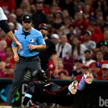 Cincinnati Reds shortstop Elly De La Cruz (44) dives into first as Detroit Tigers third baseman Gio Urshela (13) misses the out by stepping off the bag in the ninth inning of the MLB game between the Cincinnati Reds and the Detroit Tigers at Great American Ball Park in Cincinnati on Friday, July 5, 2024.