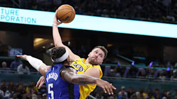 Mar 24, 2025; Orlando, Florida, USA; Los Angeles Lakers guard Luka Doncic (77) passes teh ball against the Orlando Magic in the second quarter at Kia Center. Mandatory Credit: Nathan Ray Seebeck-Imagn Images