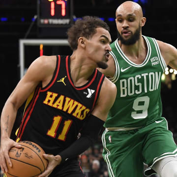 Feb 7, 2024; Boston, Massachusetts, USA;  Atlanta Hawks guard Trae Young (11) controls the ball while Boston Celtics guard Derrick White (9) defends during the first half at TD Garden. Mandatory Credit: Bob DeChiara-USA TODAY Sports