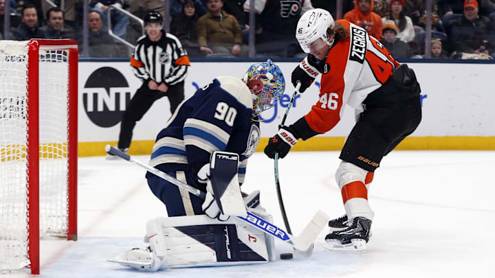 Jan 28, 2026; Columbus, Ohio, USA; Columbus Blue Jackets goalie Elvis Merzlikins (90) makes a pad save on the shot from Philadelphia Flyers center Trevor Zegras (46) during the first period at Nationwide Arena. Mandatory Credit: Russell LaBounty-Imagn Images