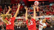 Nebraska outside hitter Harper Murray lobs a ball over the Alumni team's Callie Schwarzenbach and Lindsay Krause during the Alumni Match.