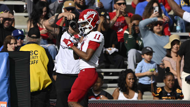New Arkansas Razorbacks receiver Raylen Sharpe celebrates a touchdown last season against UCL