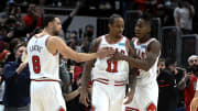 Feb 24, 2022; Chicago, Illinois, USA;  Chicago Bulls forward DeMar DeRozan (11) celebrates with Chicago Bulls guard Zach LaVine (8) and Chicago Bulls guard Ayo Dosunmu (12) after he scores against the Atlanta Hawks at the end of the second half at the United Center.