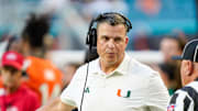 Nov 8, 2025; Miami Gardens, Florida, USA; Miami Hurricanes head coach Mario Cristobal talks to an official during a timeout in a game against the Syracuse Orange during the second quarter at Hard Rock Stadium. Mandatory Credit: Jeff Romance-Imagn Images