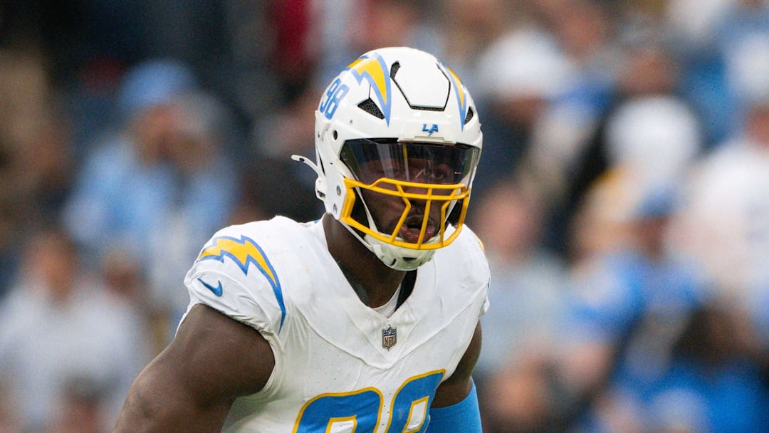 Nov 2, 2025; Nashville, Tennessee, USA;  Los Angeles Chargers linebacker Odafe Oweh (98) celebrates his sack with linebacker Tuli Tuipulotu (45) against the Tennessee Titans during the second half at Nissan Stadium. Mandatory Credit: Steve Roberts-Imagn Images
