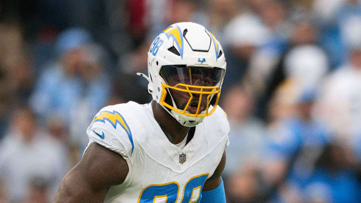 Nov 2, 2025; Nashville, Tennessee, USA;  Los Angeles Chargers linebacker Odafe Oweh (98) celebrates his sack with linebacker Tuli Tuipulotu (45) against the Tennessee Titans during the second half at Nissan Stadium. Mandatory Credit: Steve Roberts-Imagn Images