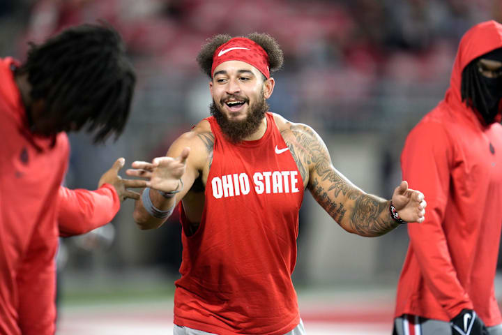Ohio State Buckeyes wide receiver Julian Fleming jokes around with teammates before a game against Michigan State.