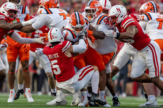 Nebraska linebacker John Bullock brings down Illinois running back Kaden Feagin after a short gain against Illinois.