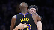 Nov 18, 2025; Los Angeles, California, USA; Los Angeles Lakers guard Austin Reaves (15) is embraced by forward LeBron James (23) in the second quarter at Crypto.com Arena. Mandatory Credit: Kirby Lee-Imagn Images
