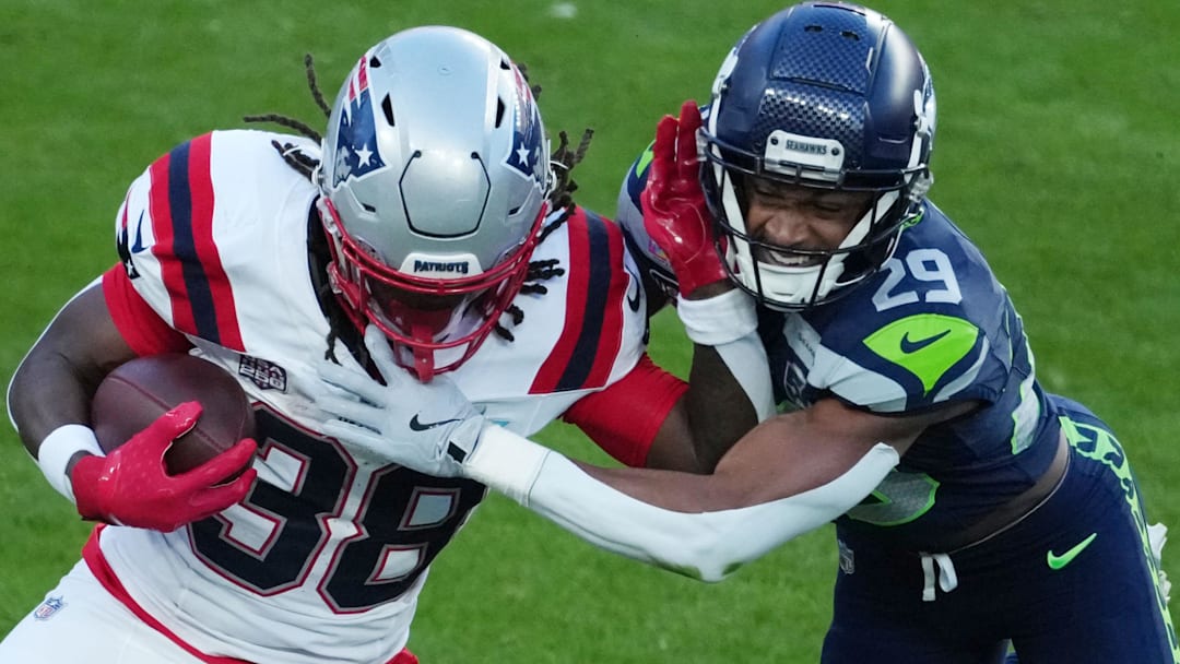 Feb 8, 2026; Santa Clara, CA, USA;  New England Patriots running back Rhamondre Stevenson (38) is tackled by Seattle Seahawks cornerback Josh Jobe (29) in the first half in Super Bowl LX at Levi's Stadium. Man